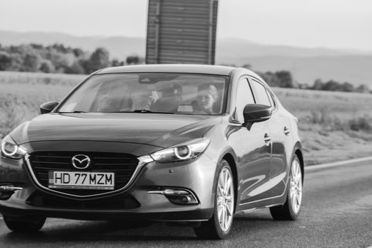 Traveling Mazda car in motion on asphalt road, front view of car on street. Bucharest, Romania, 2020