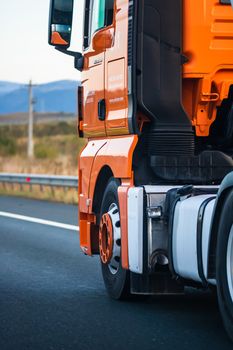 Side view of loaded European truck in motion on asphalt road, transportation and delivery concept. Detail on delivery truck. Bucharest, Romania, 2020