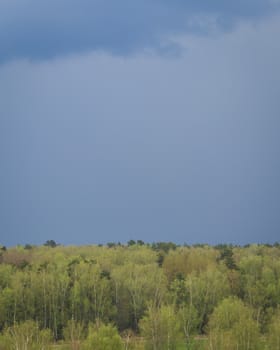 Dark blue heavy storm clouds before a thunderstorm or hurricane. Dramatic clouds in overcast weather. Cloudscape.