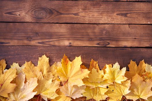 Autumn leaves frame on wooden background top view Fall Border yellow and Orange Leaves vintage wood table Copy space for text