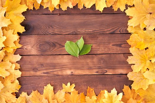 Autumn leaves frame on wooden background top view Fall Border yellow and Orange Leaves vintage wood table Copy space for text