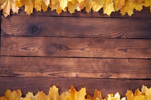 Autumn leaves frame on wooden background top view Fall Border yellow and Orange Leaves vintage wood table Copy space for text