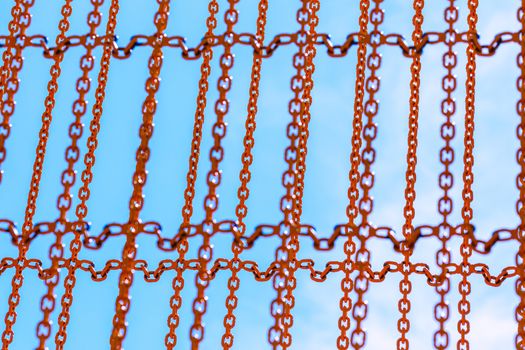 yellow chains on blue sky background with selective focus