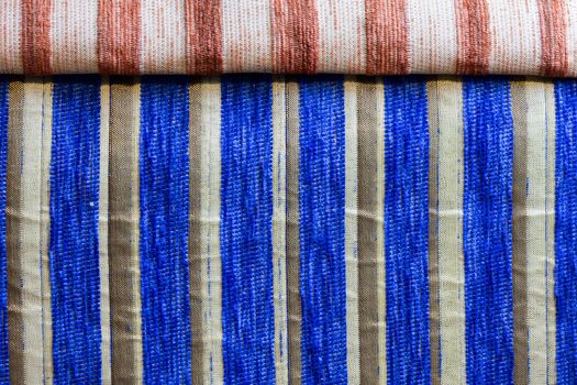 blue striped synthetic woven upholstery fabric close-up texture and background