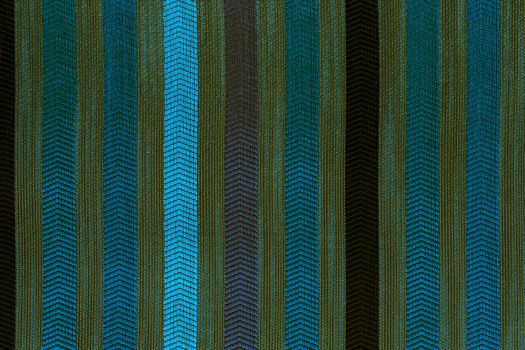 Vertically striped flat polyester upholstery dark colored texture and background