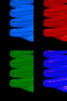 set of colored CFL neon light bulbs on black background.