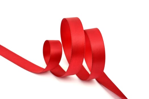 Curl of red beautiful Satin silk holiday ribbon on a white background. copy Space for text.