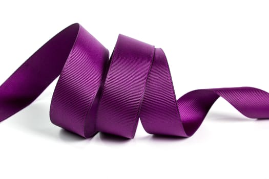 Curl of purple beautiful Satin silk holiday ribbon on a white background. copy Space for text.