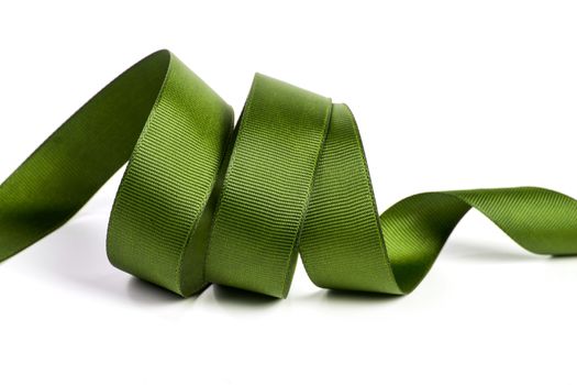 Curl of green beautiful Satin silk holiday ribbon on a white background. copy Space for text.