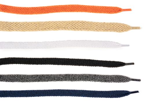 Collection of colored cotton laces for shoes with tip on white background