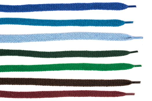 Collection of colored cotton laces for shoes with tip on white background