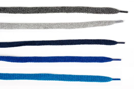 Collection of colored cotton laces for shoes with tip on white background