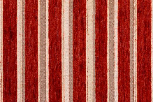 red vertical striped synthetic woven upholstery fabric close-up texture and background