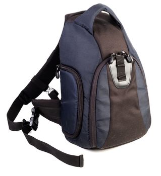 Used black and blue fabric camera bag isolated on white background.