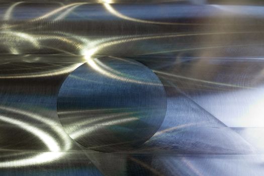 Large metal surface after end milling by large shell mill with specific concentric notches and light reflections. Selective focus closeup technique