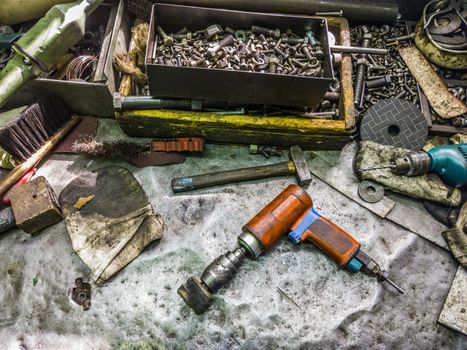 old metal dirty poor workbench backround with wariety of used tools