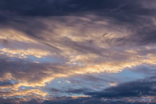 mixed clouds and blue evening sky telephoto skyscape