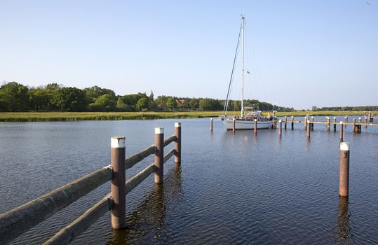 Sailboat moored at marina in beautiful landscape