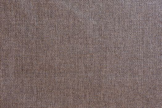 Structure of the ginger cloth with natural texture. Cloth backdrop. The texture of gray fabric textile upholstery of furniture.