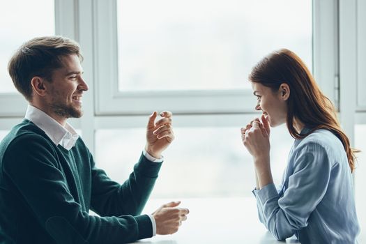 A man and a woman are sitting at the table communication dating colleagues at work