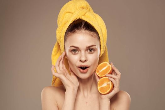 cheerful woman with oranges in her hands clean skin spa treatments. High quality photo