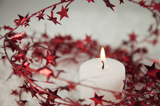 Red Christmas star glitter decoration with candlelight