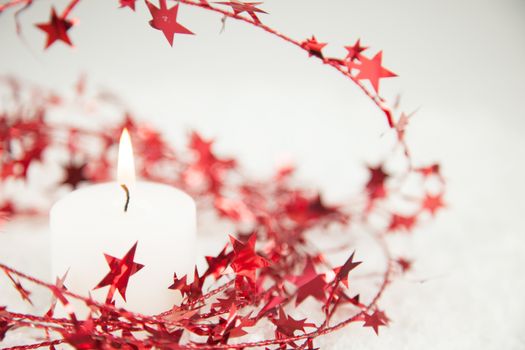 Red Christmas star glitter decoration with candlelight