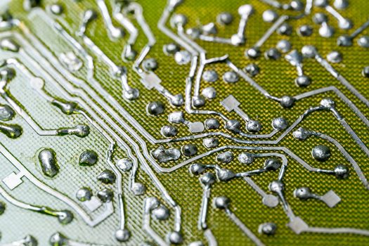back side of old flat bare fiberglass pcb without components with selective focus