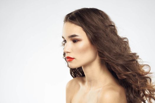 Elegant woman with bare shoulders red lips glamor attractive look cropped look. High quality photo