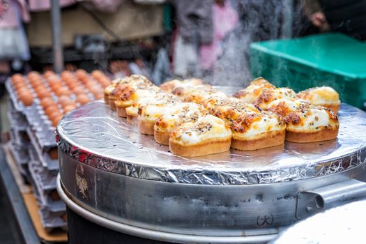 Egg bread with almond, peanut and sunflower seed at Myeong-dong street food, Seoul, South Korea 