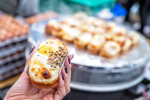 Egg bread with almond, peanut and sunflower seed at Myeong-dong street food, Seoul, South Korea 