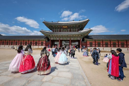 Seoul, South Korea - April 2018 : Tourist wearing traditional dress "hanbok" going to Gyeongbokgung Palace which is one of the most famous landmark in Seoul, South Korea