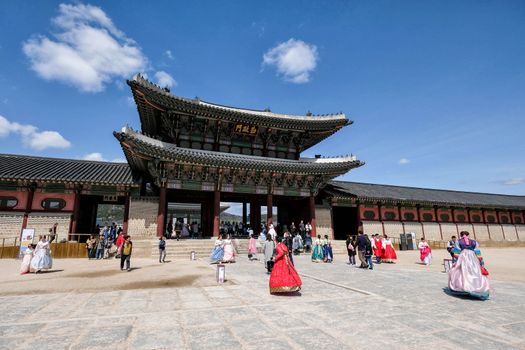 Seoul, South Korea - April 2018 : Tourist wearing traditional dress "hanbok" going to Gyeongbokgung Palace which is one of the most famous landmark in Seoul, South Korea