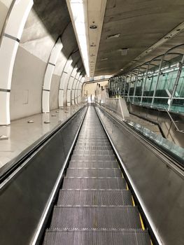 Escalator in metro. Moving down staircase Close up floor platform metal line steel. yellow gray steel line.Moving