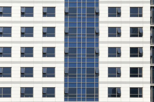 Glass windows of white office building background