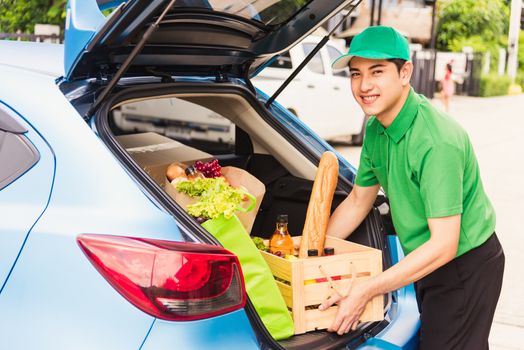 Asian delivery man grocery prepare service giving fresh vegetables food and fruit full in wooden basket on back car to send woman customer at door home after pandemic coronavirus, Back to new normal