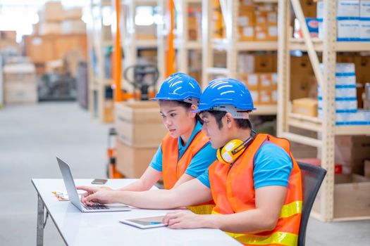 Warehouse man and woman or factory workers sit on chairs and discuss together about stock of products in workplace area. Concept of good management and happiness of staff work industrial business.