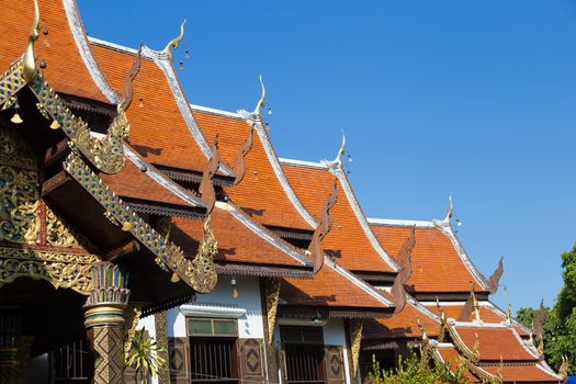 Thailand dog temple, Wat Ket Karem,roofs, red with dragon motifs with statues and sleeping dogs and votive offerings. High quality photo