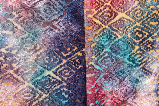 Detailed close up view on samples of cloth and fabrics in different colors found at a fabrics market.