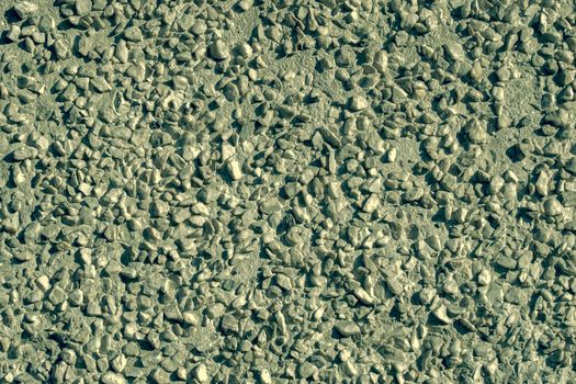 View from the front. Small pebbles in concrete. Abstraction.