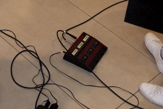 On the floor. There's a guitarist nearby. We've had his legs in sneakers and wires.