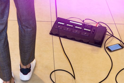 On the floor. There's a guitarist nearby. We've had his legs in sneakers and wires.