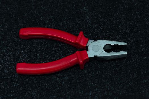 Pliers tool on black background for works