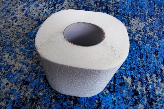 A roll of toilet paper on a blue background