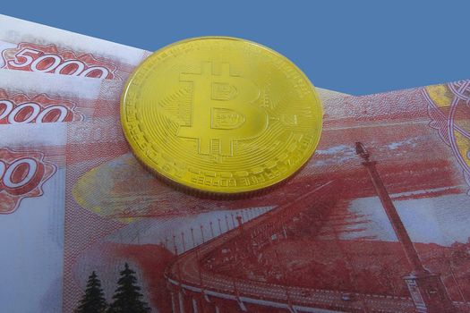 Bitcoin coin on a wad of money. Top view