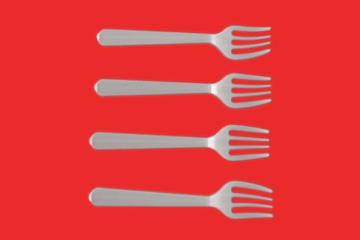 four plastic white forks on a red background
