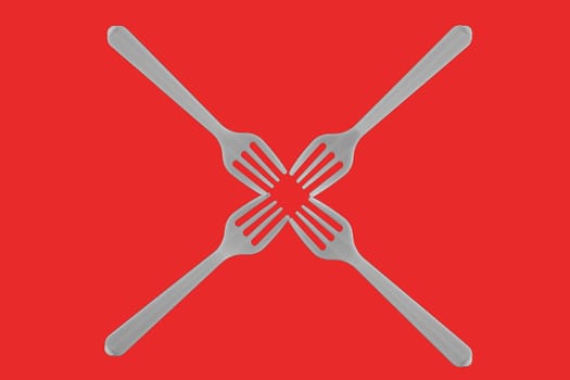 four plastic white forks on a red background