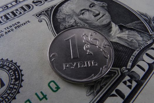 One ruble coin on a paper dollar. National currency devaluation