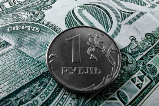 One ruble coin on a paper dollar. National currency devaluation
