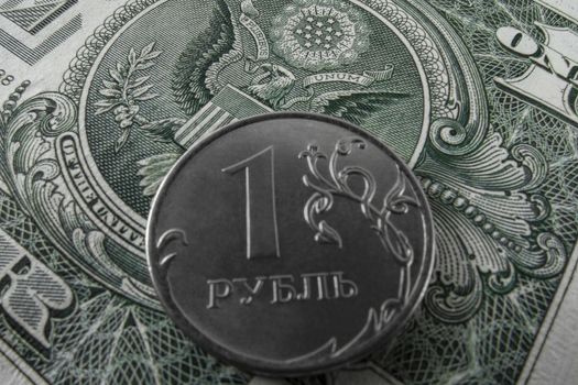 One ruble coin on a paper dollar. National currency devaluation